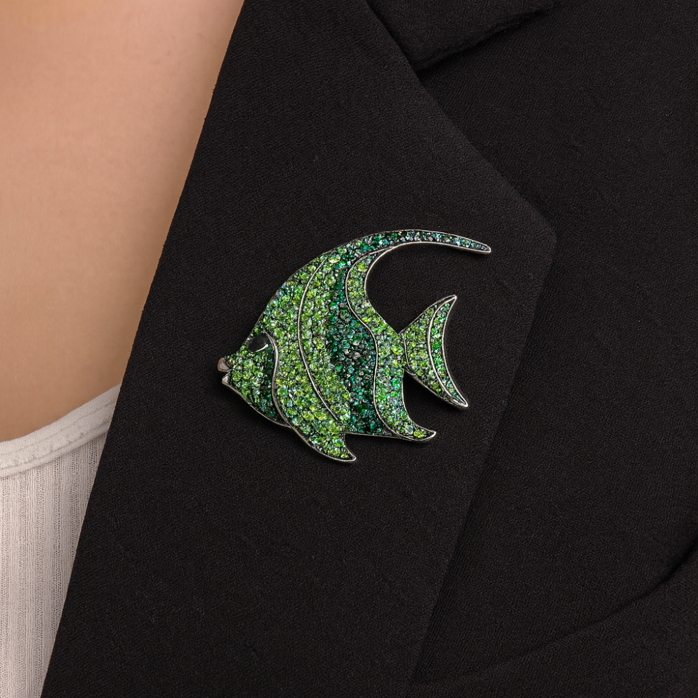 Stylish fish-shaped brooch decorated with sparkling green rhinestones of various shades. (6502)