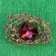 Brooch with a large burgundy crystal and a scattering of decorative stones (6702)